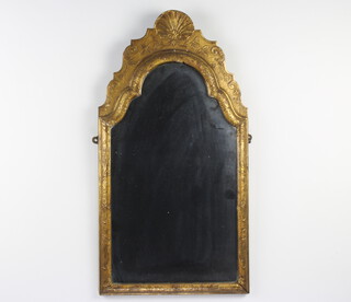 A 19th Century arched plate mirror contained in a gilt frame surmounted by a shell 70cm h x 36cm w 