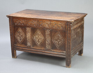 A 17th/18th Century carved oak coffer of panelled construction with hinged lid and iron lock 68cm h x 106cm w x 54cm d 