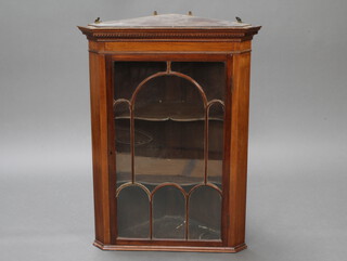 A 19th Century mahogany hanging corner cabinet with moulded and dentil cornice, fitted adjustable shelves enclosed by an astragal glazed panelled door 98cm h x 73cm w x 51cm d 