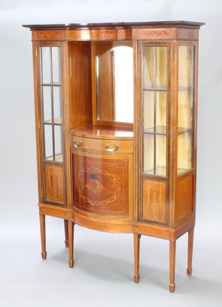 An Edwardian inlaid mahogany display cabinet with inlaid apron above a niche and arch bevelled plate mirror, having a drawer and cupboard and flanked by a pair of cupboards below, raised on square tapered supports, spade feet 175cm h x 122cm w x  43cm d 