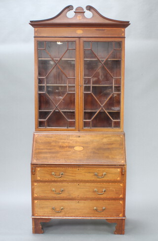 An Edwardian Georgian style inlaid mahogany bureau bookcase with broken pediment to the top, fitted shelves enclosed by astragal glazed panelled doors, the base with fall front revealing a well fitted interior above 3 long graduated drawers, raised on bracket feet 224cm h x 92cm w x 43cm d 