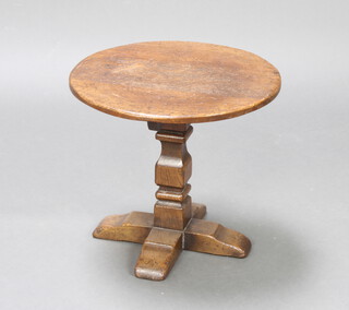 A circular oak occasional table raised on a square column and cruciform base 40cm h x 45cm diam.