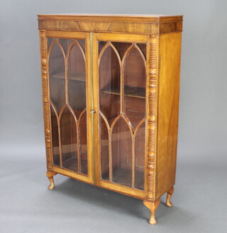 A Georgian mahogany bookcase fitted adjustable shelves, enclosed by astragal glazed panelled doors, raised on cabriole supports 125cm h x 90cm w x 30cm d 