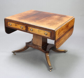 A Regency rosewood and inlaid brass pedestal sofa table fitted 2 drawers, raised on square column and triform base with splayed feet ending in brass caps and castors 70cm h x 90cm w x 74cm d 