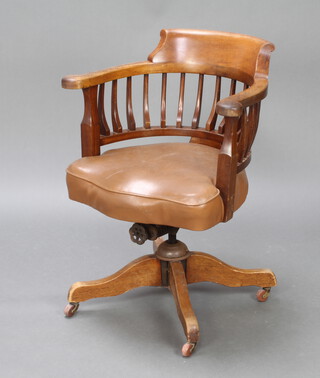An Edwardian revolving mahogany stick and tub back office chair, raised on tripod supports