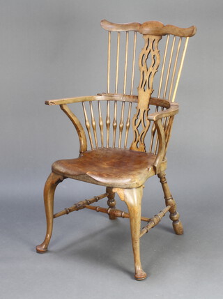 A heavily bleached mahogany Georgian style stick and rail back carver chair, raised on cabriole supports with H framed stretcher