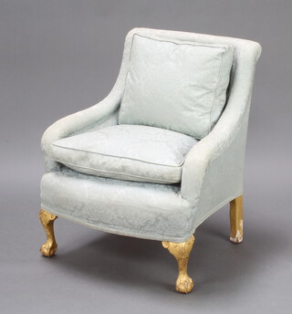 A Georgian style armchair upholstered in turquoise material and raised on gilt painted cabriole ball and claw supports