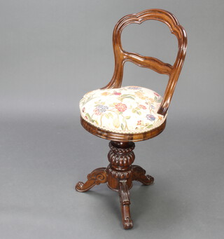 A Victorian rosewood adjustable harpests stool, raised on turned and carved column with tripod base 