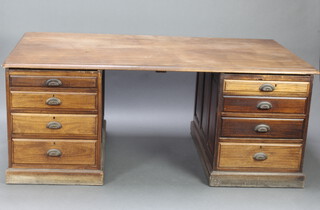 A Victorian mahogany partners desk fitted 16 short drawers with oval metal handles, raised on a platform base 75cm h x 190cm w x 104cm d 