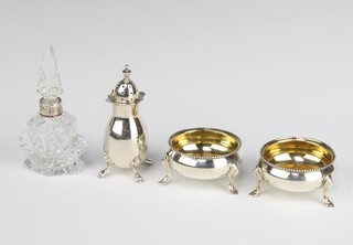 A pair of Victorian silver table salts on hoof feet, London 1890, a pepper and a silver mounted scent, weighable silver 125 grams 