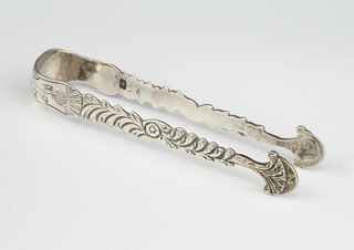 A pair of Georgian silver sugar nips with floral decoration 40 grams
