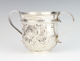 A George III silver repousse porringer with demi fluted decoration and chased armorial, London 1760, 408 grams, 13cm 
