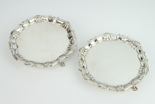 A pair of George II silver card trays with shell rims on hoof feet, London 1740, maker Robert Abercromby 15cm, 264 grams