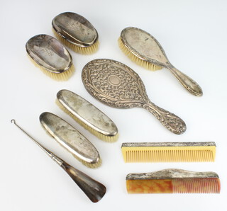 A pair of silver hair brushes Birmingham 1919, 2 similar clothes brushes, hair brush, hand mirror, 2 combs and as shoe horn 