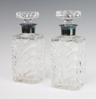 A pair of square spirit decanters and stoppers with silver collars 21cm 
