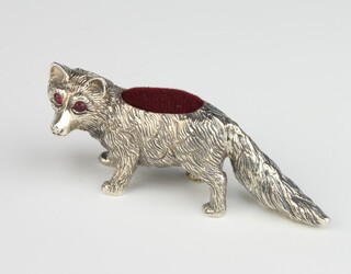 A modern Sterling silver pin cushion in the form of a standing fox with gem set eyes, gross weight 24 grams, 5cm 