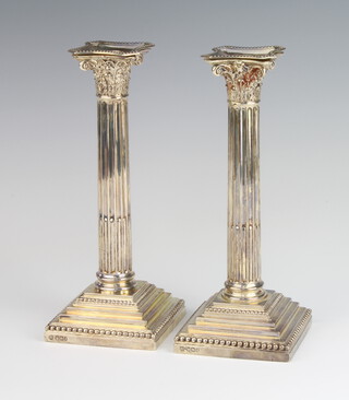 A pair of Victorian silver Corinthian column candlesticks on stepped bases Sheffield 1899, 22cm 