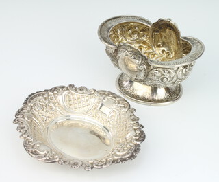 A Victorian oval repousse silver pedestal bowl decorated with flowers Sheffield 1892, a similar bon bon dish, 220 grams 