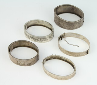 A silver engraved bangle Birmingham 1884, 4 others, 105 grams