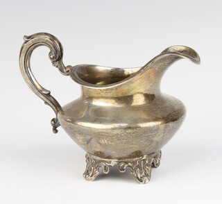 A Victorian silver cream jug with S scroll handle and scroll legs, London 1865, 9cm, 152 grams