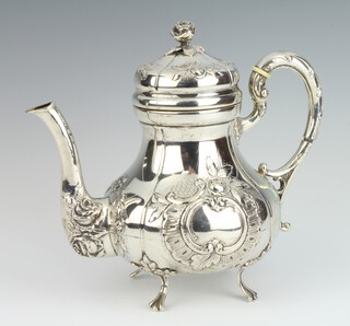 A Continental 800 standard silver baluster repousse teapot with S scroll handle and floral decoration having a vacant cartouche with ivory resistors 21cm, gross weight 614 grams