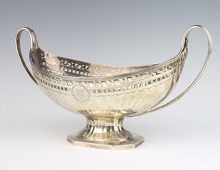 A William IV silver oval boat shaped bowl with fret work rim and scroll handles, having a chased armorial, London 1832, 35cm, 694 grams
