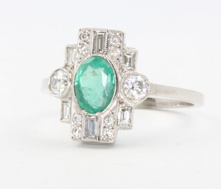 A platinum emerald and diamond cluster ring, the emerald approx. 0.75ct, diamonds 0.6ct, size P, 4.6 grams 