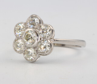 A platinum and diamond 7 stone cluster ring, size O, 1.5ct, 5.2 grams 