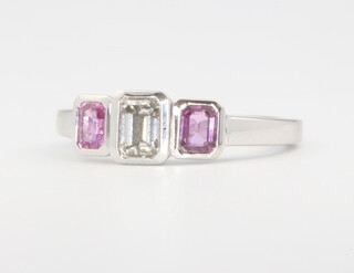 An 18ct white gold emerald cut diamond and pink sapphire ring, centre diamond approx. 0.51ct flanked by pink sapphires 0.57ct, size M 