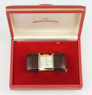 A Movado gilt metal leather mounted travelling bedroom timepiece in original box 