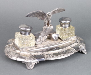An Edwardian silver plated ink stand with an eagle sitting on a rock flanked by inkwells, raised on scroll feet 28cm 