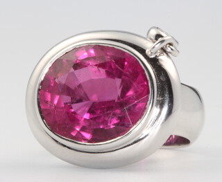 An 18ct white gold oval pink tourmaline ring with drop diamond, centre stone approx. 18ct, the brilliant cut diamond 0.12ct, size N 