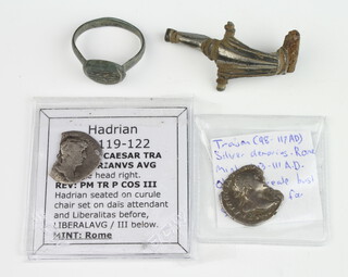 Two Roman silver denarius, a fibula and a ring   