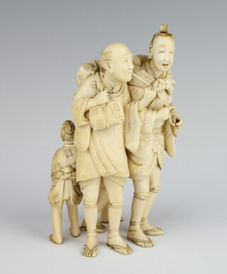 A Japanese Meiji period carved ivory okimono of 2 pipe smoking gentleman with 2 children playing behind their back 15cm 