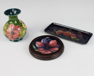 A modern Moorcroft rectangular pin tray decorated with birds and fruit 20cm, ditto circular dish framed 14cm and a green ground baluster vase 14cm 
