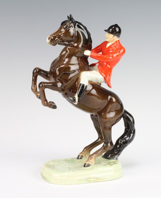 A Beswick figure of a rider on a rearing brown glazed horse 868 26cm 