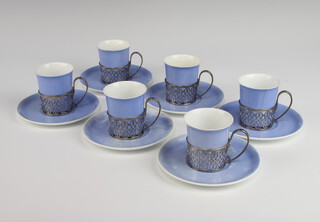 Six Shelley coffee cups and saucers contained in pierced silver holders, Birmingham 1938 