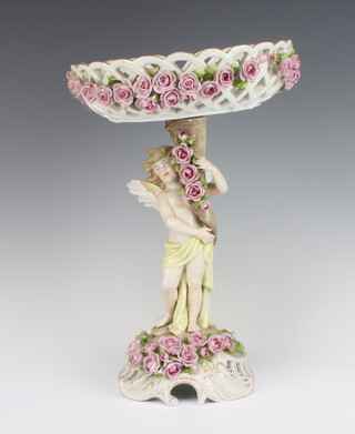 A German porcelain Dresden style centrepiece with a pierced basket decorated with roses, raised on a base supported by a cherub 37cm 