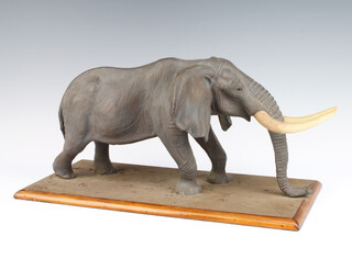 Tom Kenya, a composition figure of an elephant raised on a wood base 49cm 