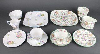 A Minton Haddon Hall part tea set comprising 6 tea cups, 6 saucers, 1 sugar bowl, 6 sandwich plates, a cake plate and a cream jug together with a Shelley Wild Flowers part tea set - 6 tea cups (1 cracked), 6 saucers, cream jug, sugar bowl, 6 small plates and a sandwich plate 