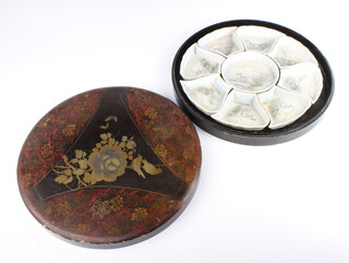 A Japanese 9 piece hors d'oeuvres set decorated with birds enclosed in a circular lacquered box 
