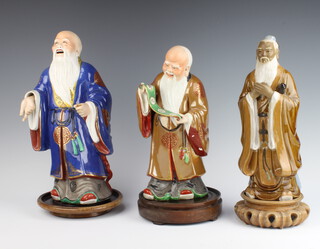 A modern Chinese Earthenware figure of a dignitary 30cm, ditto reading a scroll 29cm and a ditto of Shu Lau 35cm together with 3 wooden stands 