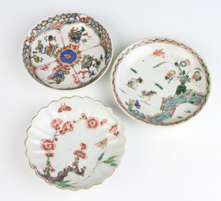 An 18th Century Chinese scalloped dish decorated with a butterfly amongst flowering peony 13cm, ditto famille verte dish decorated with dogs of fo 13cm and another decorated with a chicken and butterfly in a garden 13cm  
