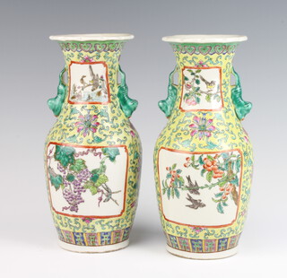 A pair of yellow ground modern Chinese vases decorated with panels of grapes and vines and with lion handles 26cm 