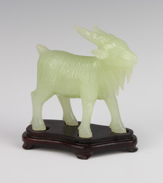 A Chinese carved hardstone figure of a goat on a carved hardwood stand 10cm 