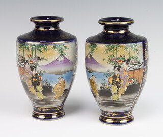 A pair of early 20th Century Japanese blue ground Satsuma vases decorated with figures before Mount Fuji 18cm 