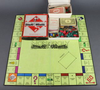 A Wartime Monopoly set with cardboard and wooden figures, wooden houses, complete with board 