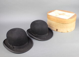 Dunn & Co, a gentleman's light weight bowler hat and 1 other complete with hat box 