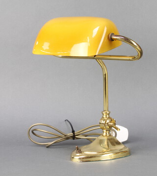 A brass bank table lamp with amber coloured glass shade 31cm h  