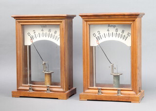 Two large electrical meters, calibrated from 0-10, contained in mahogany cases 35cm h x 24cm w x 15cm d 